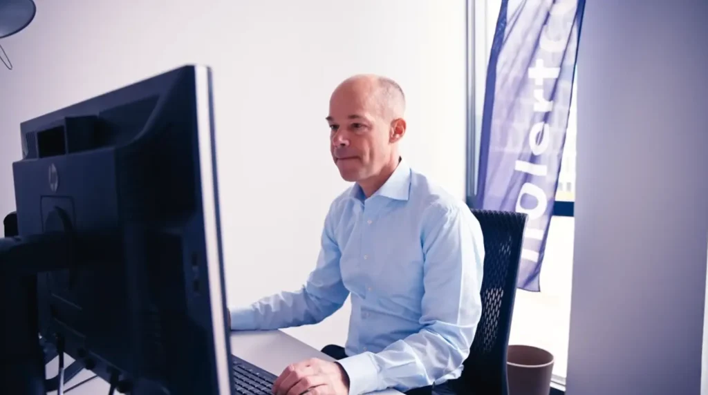 Renke Holert working on an Altus PPM deployment at a desk